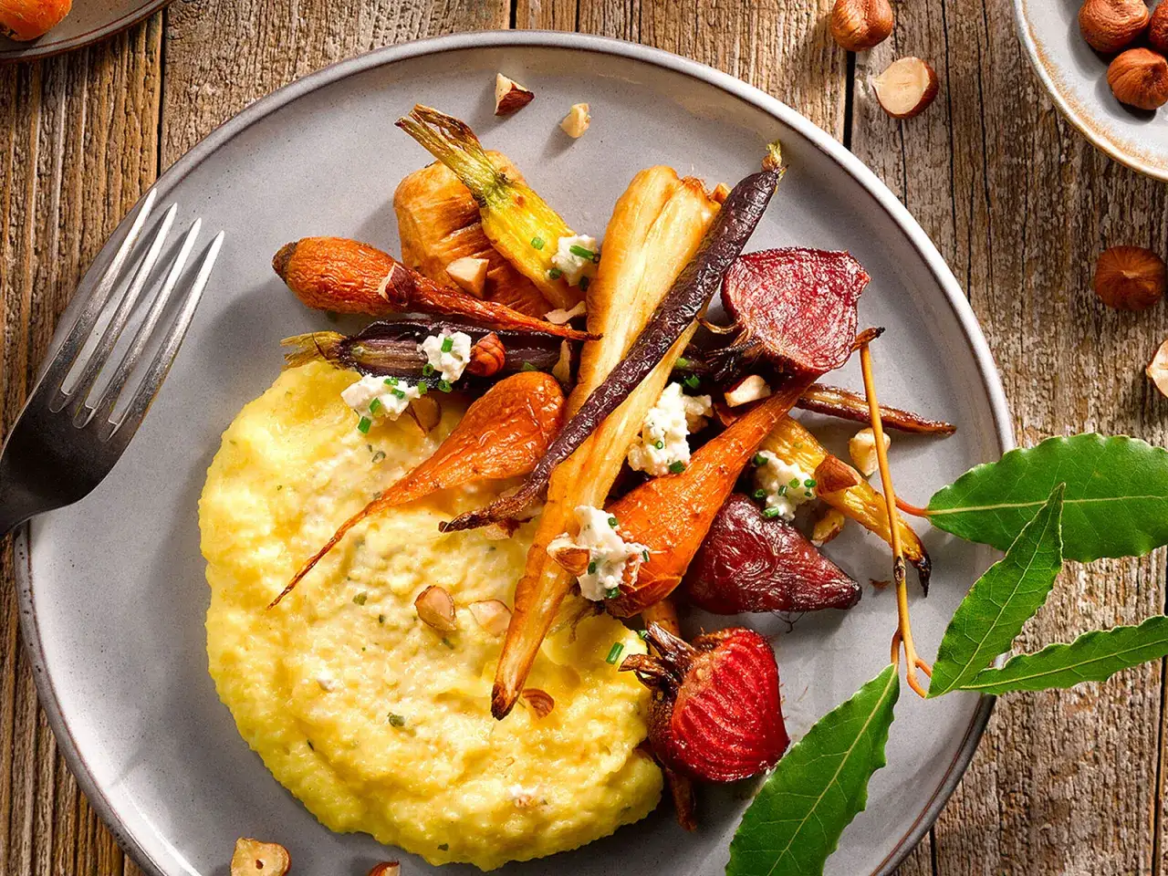 Cremige Polenta mit bunten Wurzelgemüsen und Ziegenkäse, ein Gericht, das auch Kinder lieben werden.